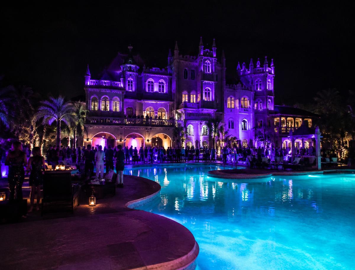 Poolside party illuminated in violet and turquoise